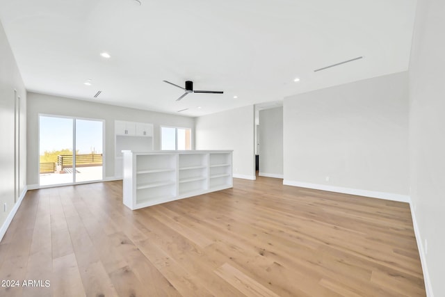 unfurnished living room featuring light wood-type flooring and ceiling fan