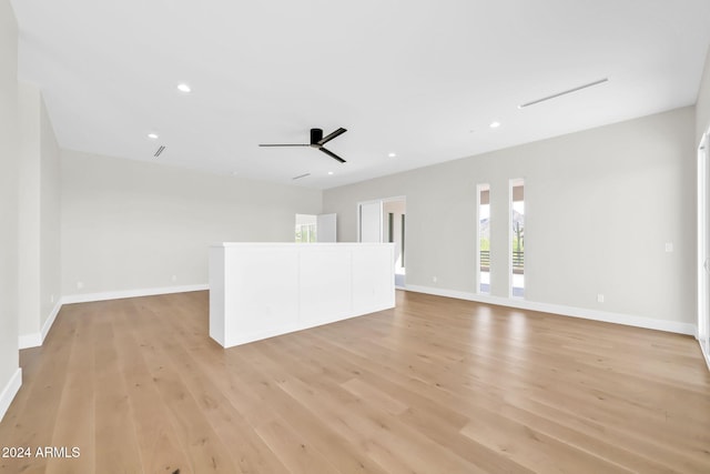 unfurnished living room with ceiling fan and light wood-type flooring