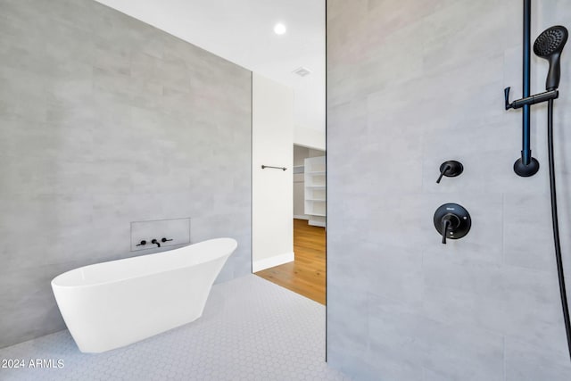 bathroom featuring tile walls, plus walk in shower, and tile patterned floors