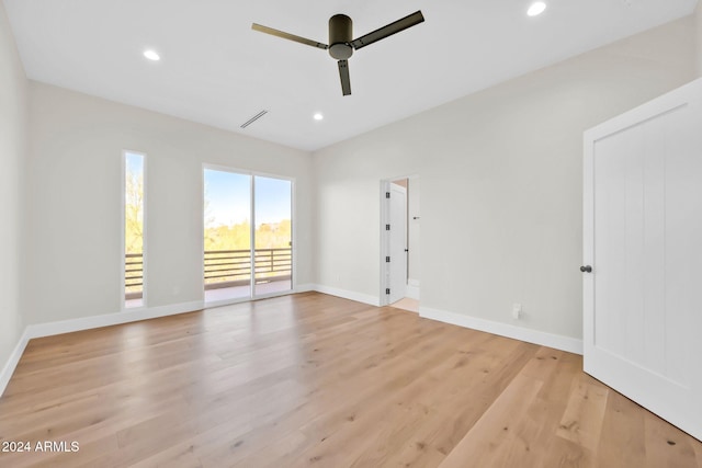 empty room with ceiling fan and light hardwood / wood-style flooring