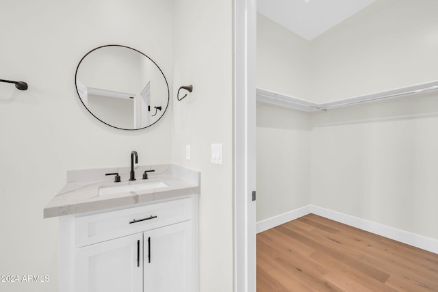 bathroom featuring hardwood / wood-style flooring and vanity