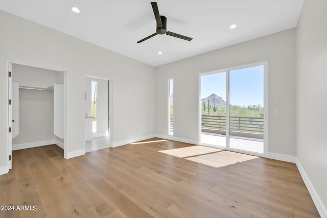 spare room with light wood-type flooring and ceiling fan