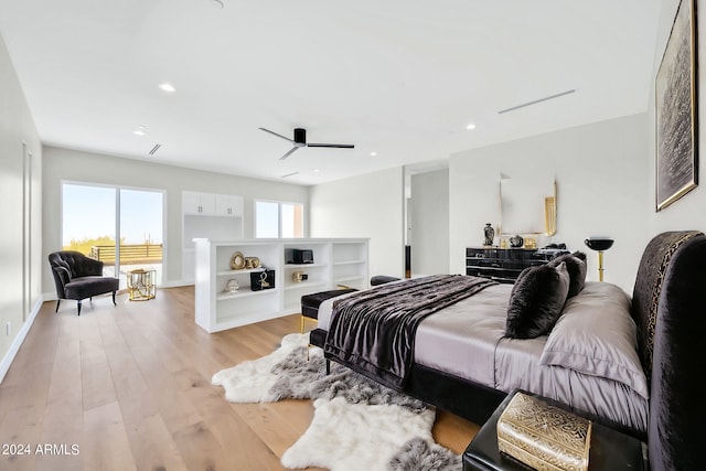 bedroom with light wood-type flooring and multiple windows