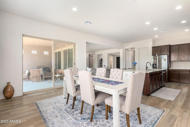 dining area with recessed lighting, visible vents, and light wood finished floors