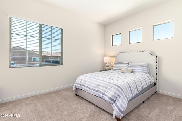 carpeted bedroom with baseboards and multiple windows