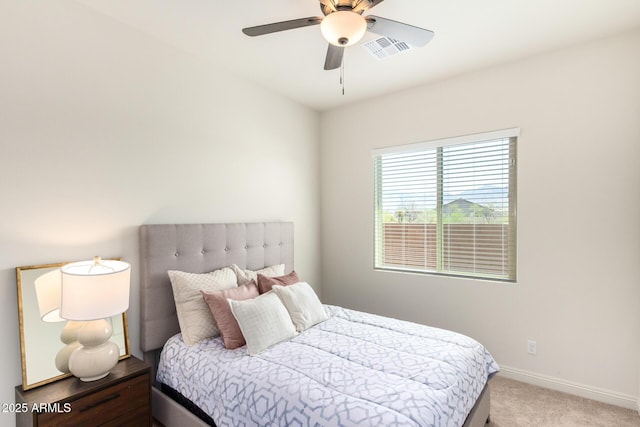 carpeted bedroom featuring visible vents, baseboards, and ceiling fan