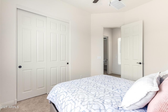 bedroom featuring visible vents, light carpet, a closet, baseboards, and ceiling fan