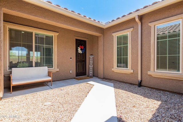 property entrance with stucco siding