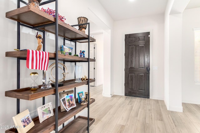 interior space featuring baseboards and wood finished floors