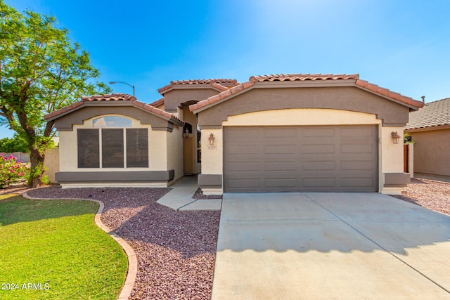 mediterranean / spanish-style house featuring a garage