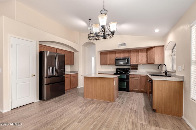 10209 W Jessie Ln, Peoria, AZ 85383 - kitchen featuring appliances with stainless steel finishes, a sink, a chandelier, light countertops, and a center island