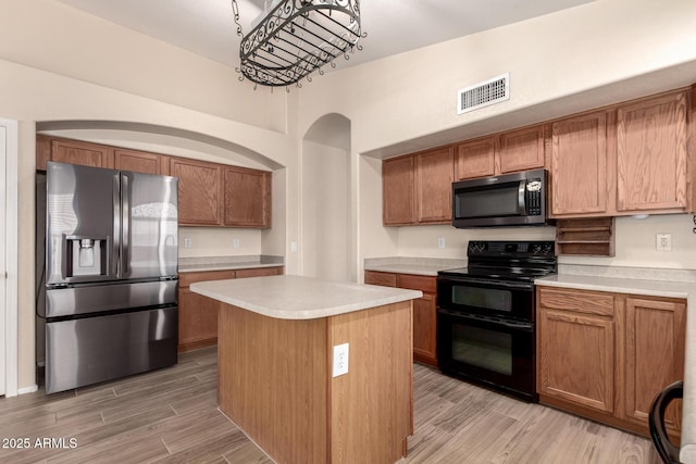 10209 W Jessie Ln, Peoria, AZ 85383 - kitchen with stainless steel appliances, light countertops, brown cabinets, and light wood-type flooring