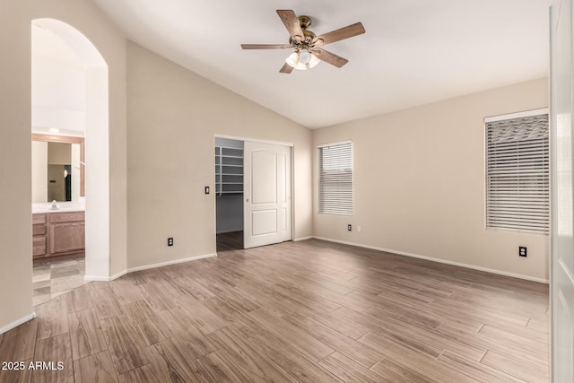 10209 W Jessie Ln, Peoria, AZ 85383 - unfurnished bedroom with light wood-style floors, vaulted ceiling, a closet, and baseboards