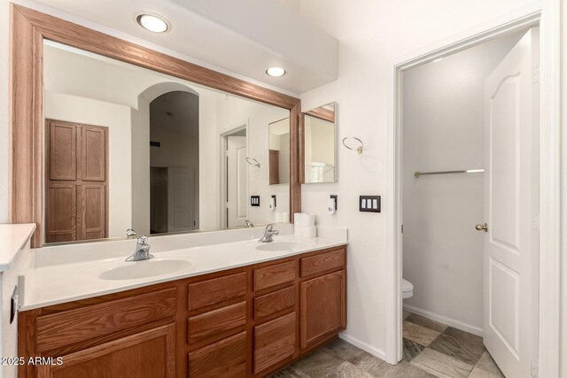 10209 W Jessie Ln, Peoria, AZ 85383 - full bathroom featuring toilet, double vanity, and baseboards