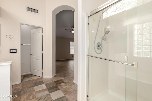 10209 W Jessie Ln, Peoria, AZ 85383 - full bath featuring a stall shower, baseboards, stone finish flooring, and ceiling fan