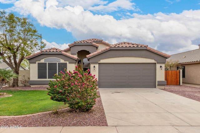 10209 W Jessie Ln, Peoria, AZ 85383 - mediterranean / spanish house with a garage, a tile roof, driveway, and stucco siding