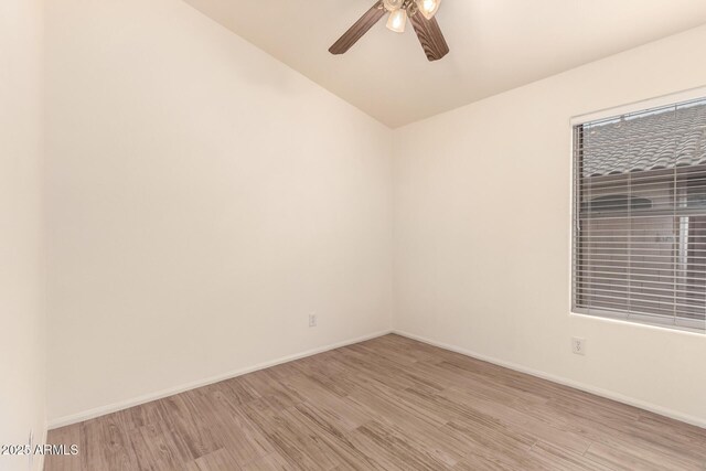 10209 W Jessie Ln, Peoria, AZ 85383 - empty room with light wood finished floors, a ceiling fan, vaulted ceiling, and baseboards