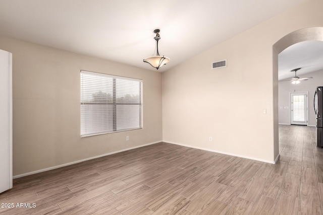 10209 W Jessie Ln, Peoria, AZ 85383 - spare room featuring arched walkways, wood finished floors, healthy amount of natural light, and baseboards