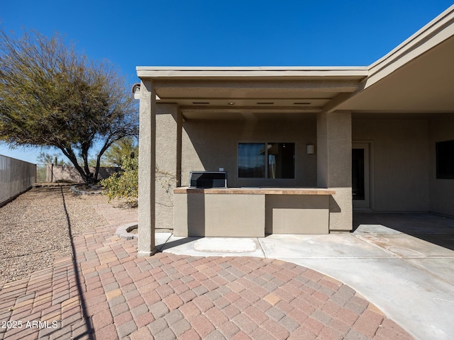 view of patio / terrace featuring fence