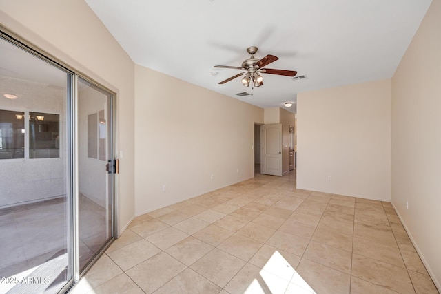 empty room with a ceiling fan, visible vents, and light tile patterned floors