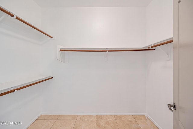 spacious closet featuring light tile patterned floors