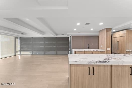 kitchen with paneled fridge, recessed lighting, modern cabinets, and light wood finished floors