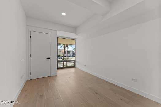 spare room with recessed lighting, baseboards, and light wood-type flooring