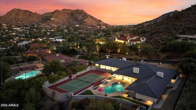 aerial view at dusk featuring a mountain view