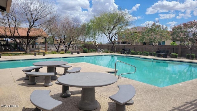 pool featuring a patio area and fence