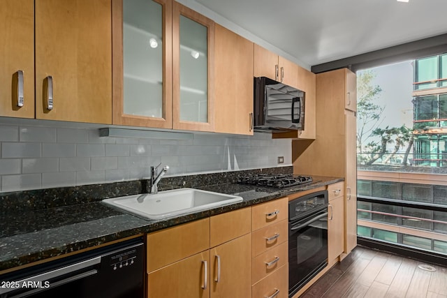 kitchen with tasteful backsplash, black appliances, sink, dark hardwood / wood-style flooring, and dark stone counters