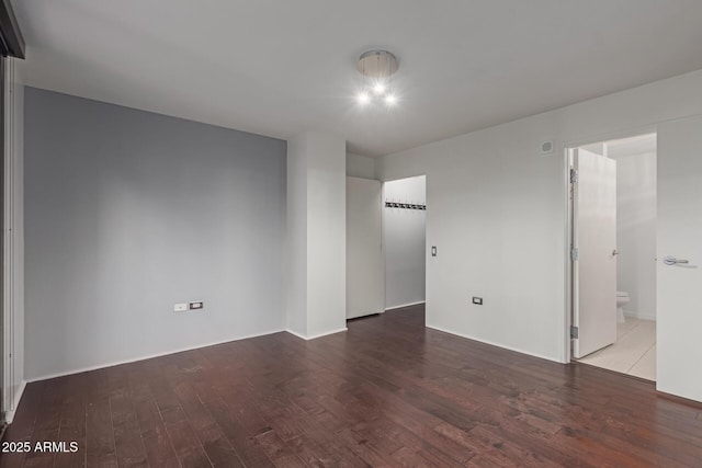 unfurnished room featuring hardwood / wood-style flooring