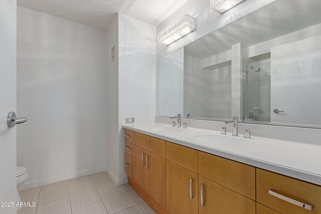 bathroom with a shower with shower door, toilet, and vanity