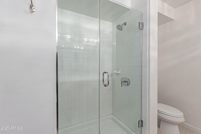 bathroom featuring toilet, tile patterned floors, and an enclosed shower