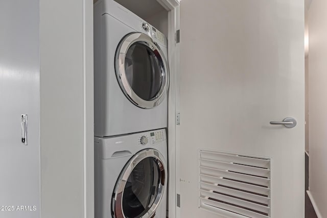 laundry area featuring stacked washer / drying machine