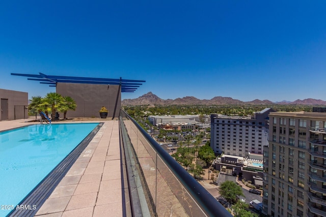 view of swimming pool with a mountain view