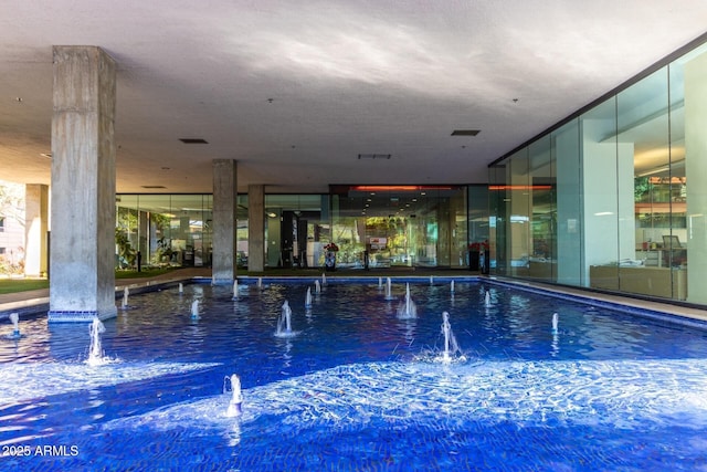 view of swimming pool with pool water feature