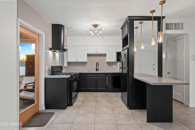 kitchen with sink, black appliances, white cabinets, exhaust hood, and kitchen peninsula