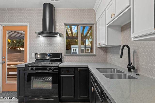 kitchen featuring black gas range, sink, white cabinets, and wall chimney exhaust hood