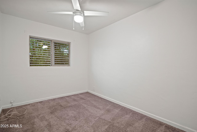 unfurnished room with ceiling fan and carpet