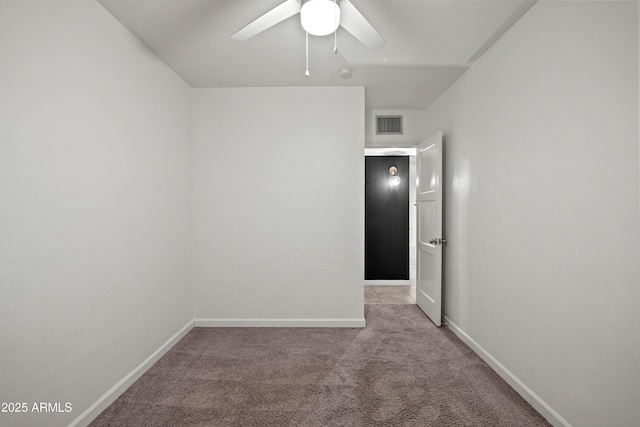 carpeted spare room featuring ceiling fan