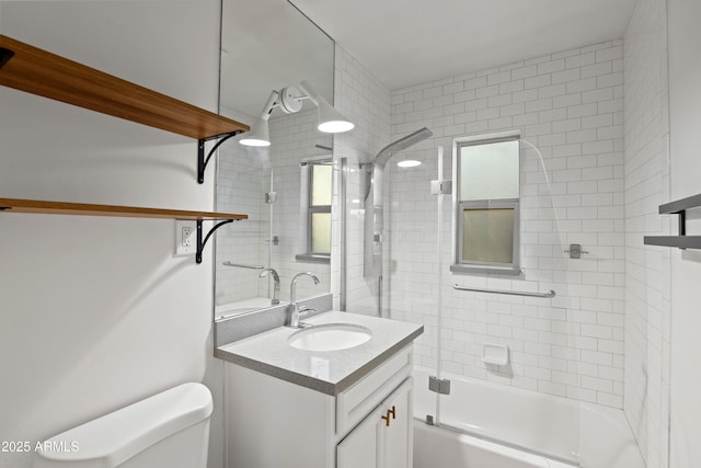 full bathroom featuring vanity, toilet, and combined bath / shower with glass door