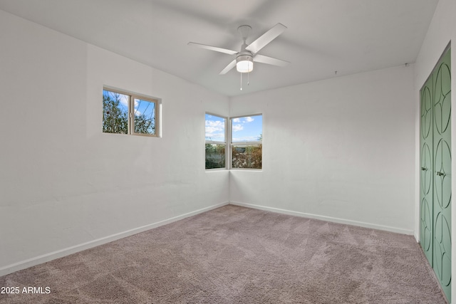 empty room featuring carpet floors and ceiling fan