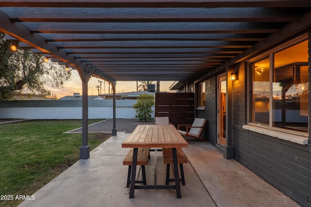 patio terrace at dusk featuring a pergola