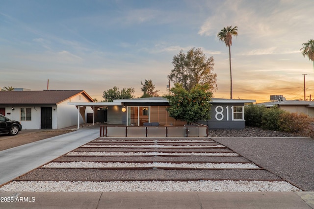 ranch-style home featuring a carport