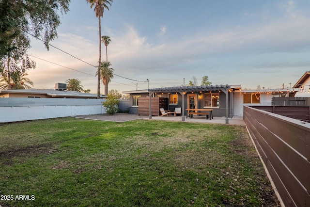 yard at dusk with a patio area