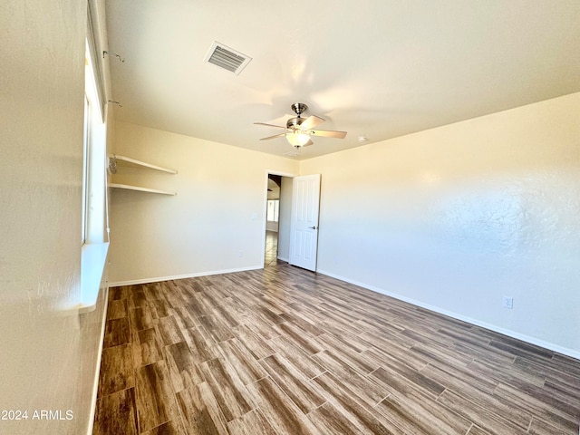 unfurnished bedroom with ceiling fan and wood-type flooring