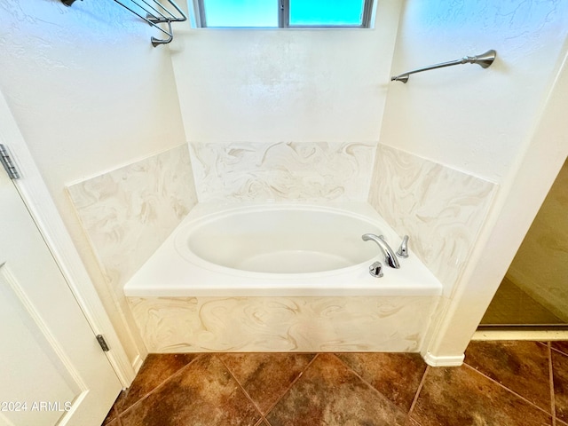 bathroom with a bathing tub and tile patterned flooring