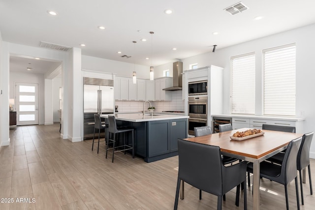 dining space featuring sink and light hardwood / wood-style flooring