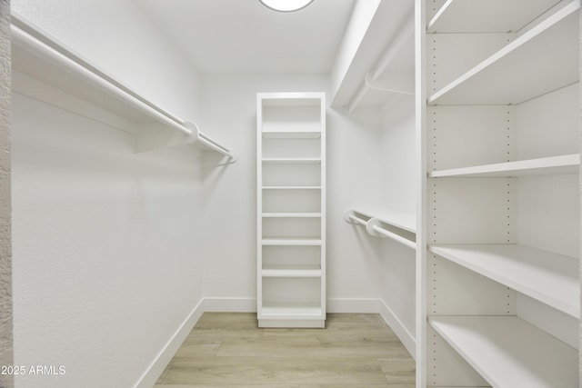10538 E Gold Dust Cir, Scottsdale, AZ 85258 - walk in closet featuring light wood finished floors
