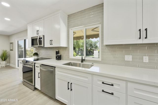 10538 E Gold Dust Cir, Scottsdale, AZ 85258 - kitchen featuring appliances with stainless steel finishes, decorative backsplash, white cabinetry, light countertops, and recessed lighting